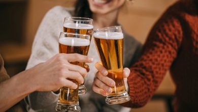 People raising their beers in a toast