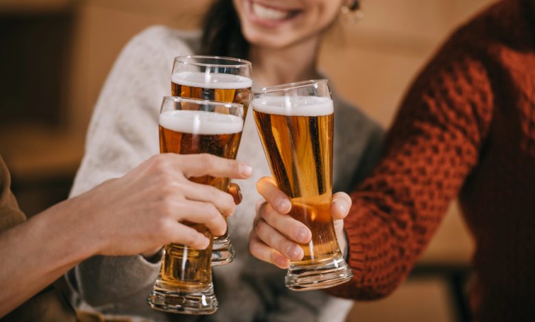 People raising their beers in a toast