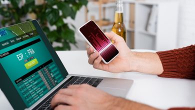 Man gambling online anonymously with a beer bottle beside