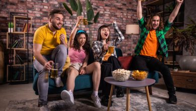 Friends enjoying beers while watching sports and enjoying betting