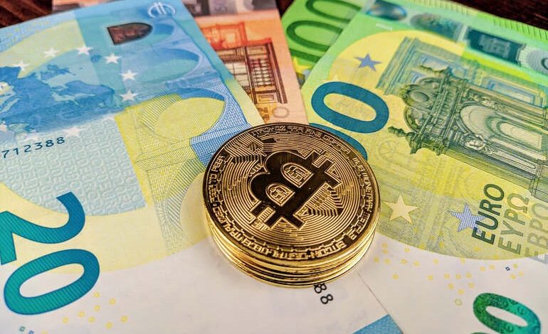 Bitcoin coin on colorful euro banknote