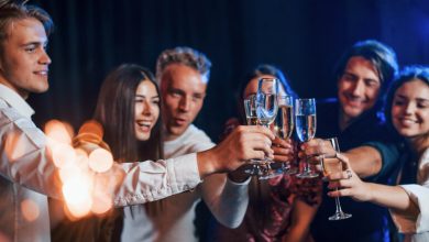 Cheerful friends celebrating New Year’s Eve with Kratom Seltzers