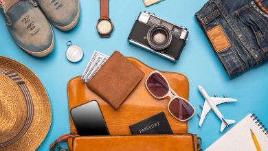 Travel essentials for Indonesia, including a wallet, sunglasses, a smartphone, etc.