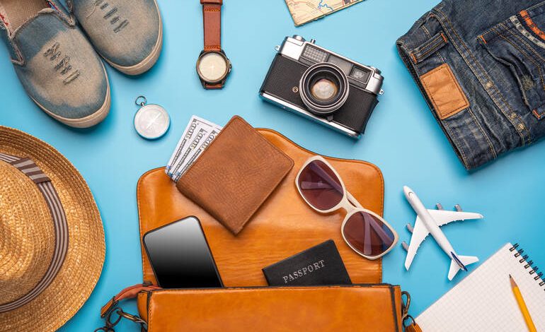 Travel essentials for Indonesia, including a wallet, sunglasses, a smartphone, etc.