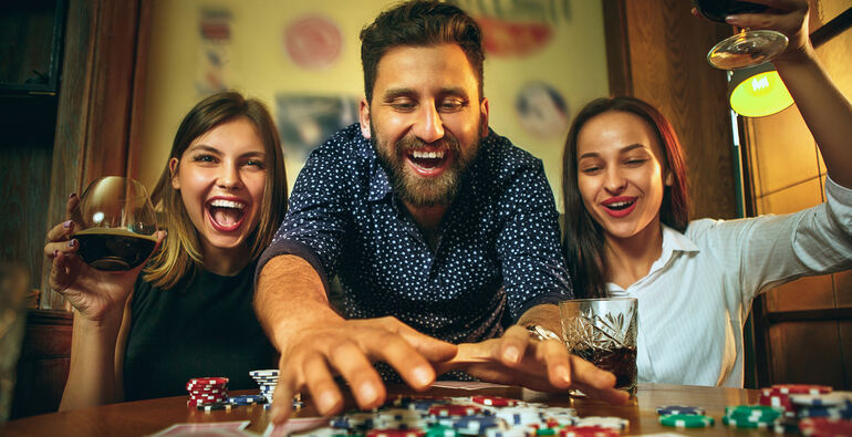 Friends enjoying beers while enjoying a fun slot game