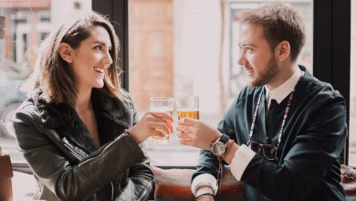 Smiling couple enjoying a beer on a modern date