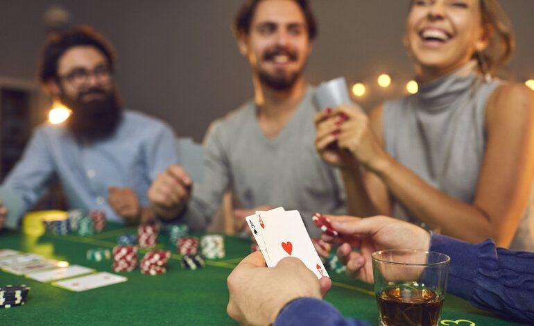 A group of friends enjoying a casino night with cards and beer in Canada