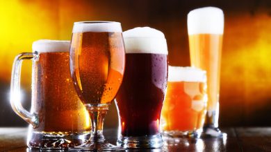 Craft beers on a wooden table, symbolizing the diversity of craft beer and its role in culture and academic research