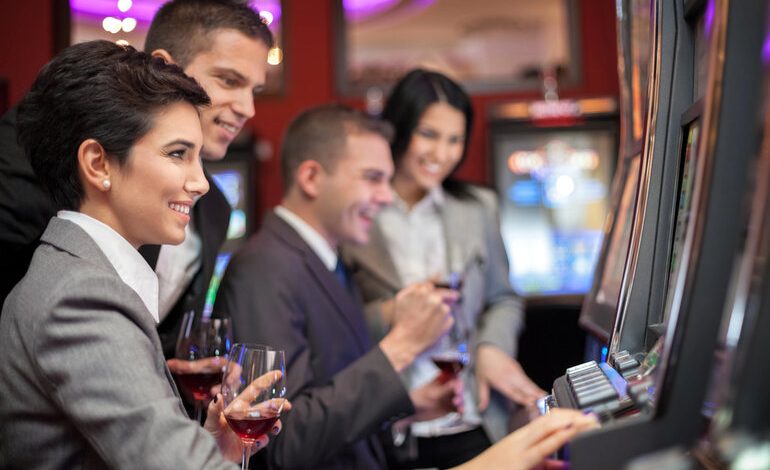 People enjoying craft beers while playing slot machines at a casino