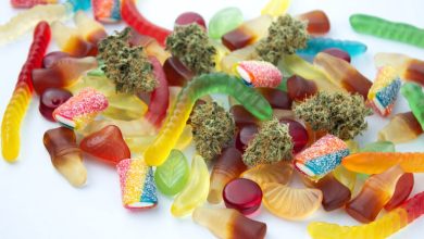 Assorted weed-infused gummies in various shapes and colors