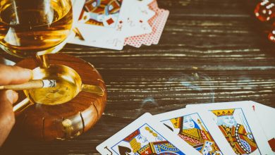 A baccarat player enjoys a game at a casino with a glass of craft beer on the table