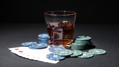 Glass of alcohol with poker chips and playing cards, exploring the psychology of gambling and alcohol