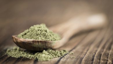 Recently purchased Kratom is displayed in a wooden spoon