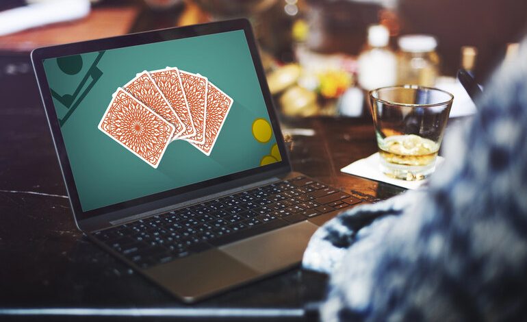 A man gambling online and drinking