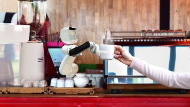 A robot serving hot coffee to people at work