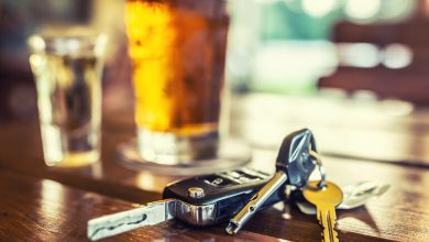 Car keys on a bar table with beer and a shot glass