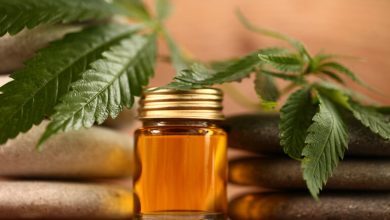 CBD oil bottle surrounded by cannabis leaves, symbolizing natural burnout recovery and stress relief