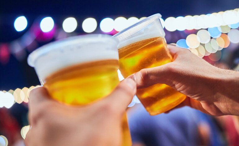 Beer lovers holding glasses of beer at an American Beer Festival