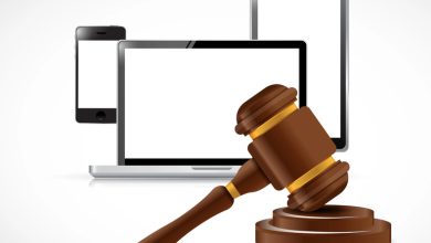 Gavel in front of digital devices symbolizing legality and regulation