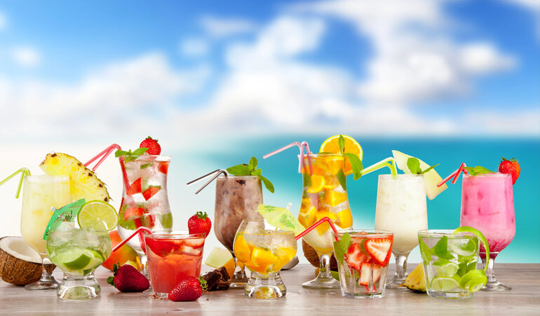 Colorful selection of popular beverages from Australia and New Zealand on a tropical beach background