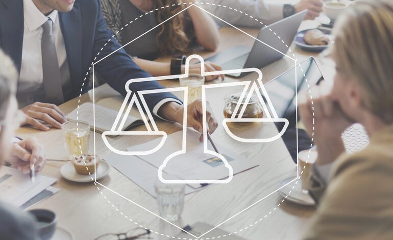 People discussing legal matters with a glass of beer, eyeglasses, and papers on the table