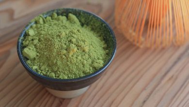 MIT 45 kratom powder in a black ceramic bowl on a wooden table