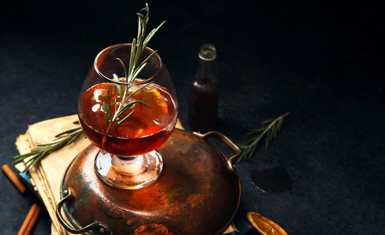 A glass of Red Spot Irish Whisky garnished with rosemary