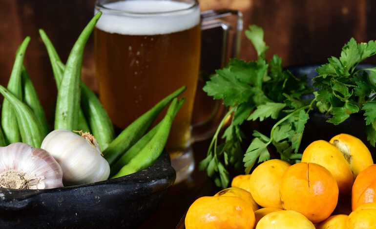 Fresh tropical vegetables and herbs with a cold craft beer