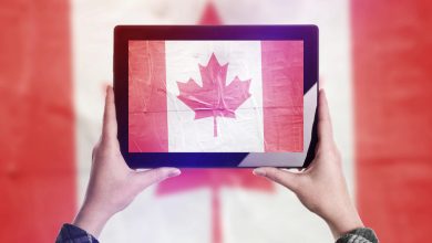 Person holding tablet displaying Canadian flag