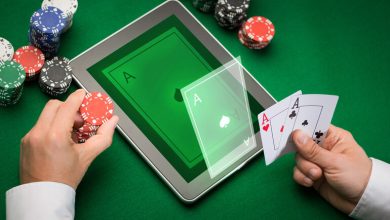 A person playing online poker on a tablet with poker chips and aces in hand