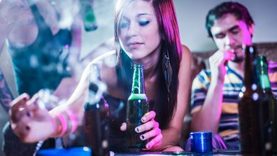 Young adults enjoying craft beer and cannabis vapes in a relaxed social setting