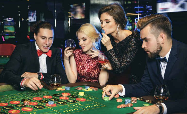 Elegant group of people playing roulette at a casino table