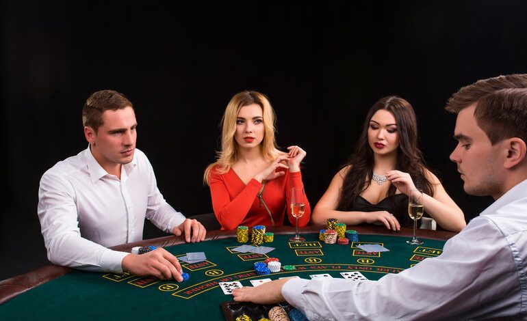 Players at a live casino table in Canada are enjoying cards, chips, and real dealer action