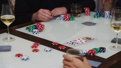 Friends enjoying a lively poker night with stacks of chips, playing cards on the table, and glasses of beer, perfect for beer-loving game enthusiasts.