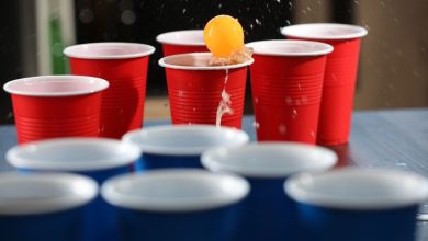 The Great Beer Pong Championship in San Diego, players competing with red and blue cups during the lively event.