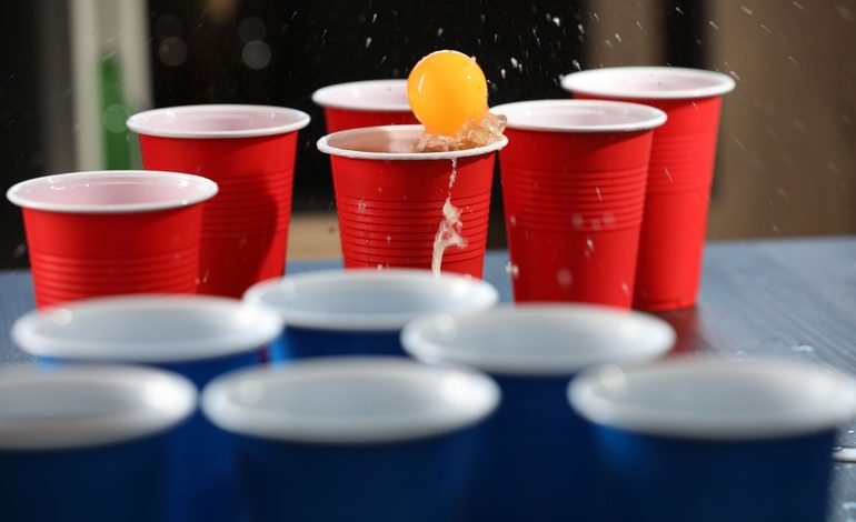 The Great Beer Pong Championship in San Diego, players competing with red and blue cups during the lively event.