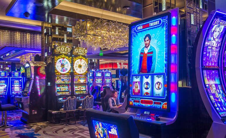 Colorful slot machines glowing on a busy casino floor, evoking the thrill of real-money mobile casinos for beer-loving players.