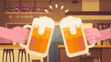 Two people clinking frothy beer mugs at a cozy craft beer bar during a singles event,