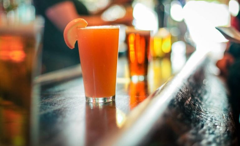 Beers on a bar counter at a San Diego brewery event.