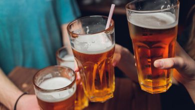 Friends clink glasses of craft beer at a local bar, using their favorite brews as a new kind of social currency in the community.