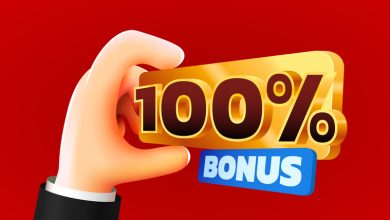 hand holding a shiny gold ‘100% bonus’ sign against a red background, representing online casino bonuses and promotional offers.