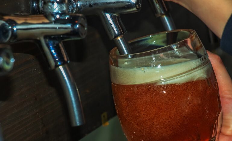 Full glass of beer at a San Diego event, highlighting responsible drinking and post-event safety efforts.