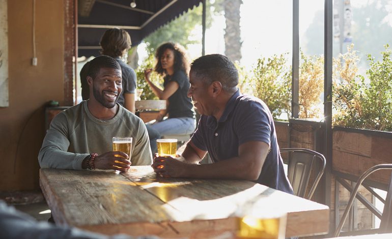 Fans celebrating with beer at a bar in Uganda