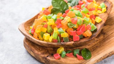 Colorful fruit-flavored gummy pieces in a wooden bowl, used to illustrate how CBD gummies can enhance the season for beer lovers.