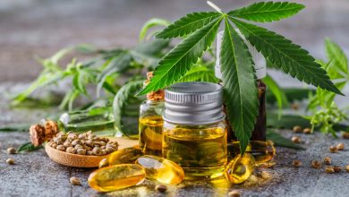CBD oil bottles, capsules, hemp seeds, and cannabis leaves displayed on a table, illustrating how to choose the right CBD products for wellness.