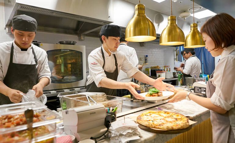 The photo was taken in one of the restaurant kitchens, where staff cook food during a busy service.