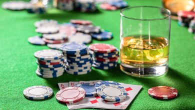 Craft beer alongside poker chips and playing cards representing modern casino gaming culture.