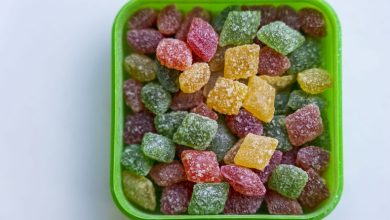 Delta-9 THC gummies in assorted colors, displayed in a green container, featured for beer lovers.