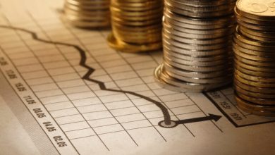 A stack of coins on an exchange rate sheet.