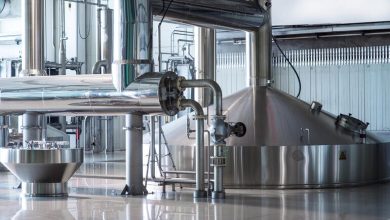 Modern brewery interior with stainless steel fermentation tanks and piping